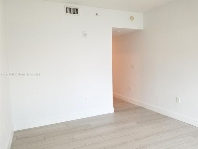 spare room with light hardwood / wood-style floors