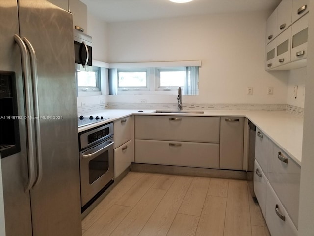 kitchen with sink, light wood-type flooring, and stainless steel appliances