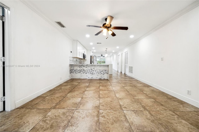 unfurnished living room with ceiling fan, light tile patterned flooring, and ornamental molding