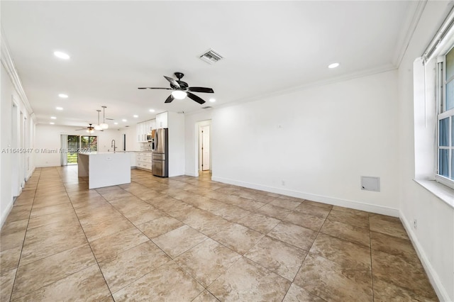 interior space featuring ceiling fan, sink, and ornamental molding