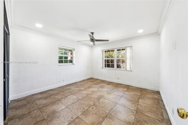 tiled empty room with ceiling fan and crown molding