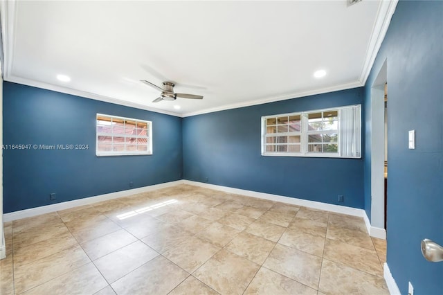 tiled empty room with ceiling fan and ornamental molding