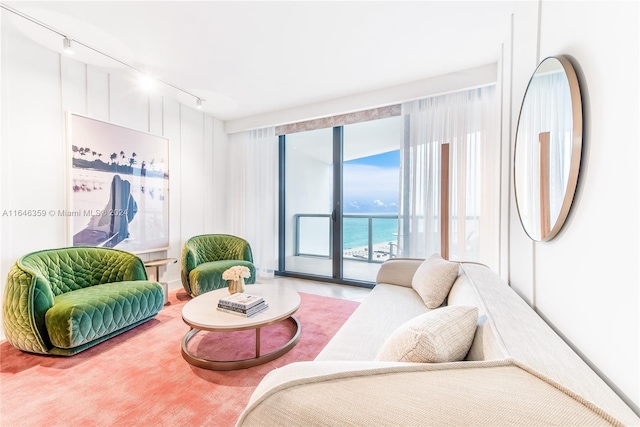 living room featuring rail lighting and a water view