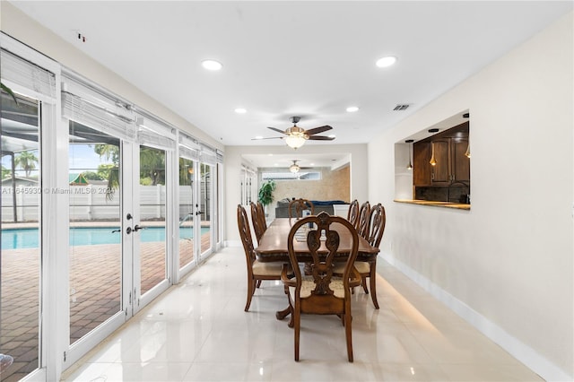 dining space with ceiling fan and french doors