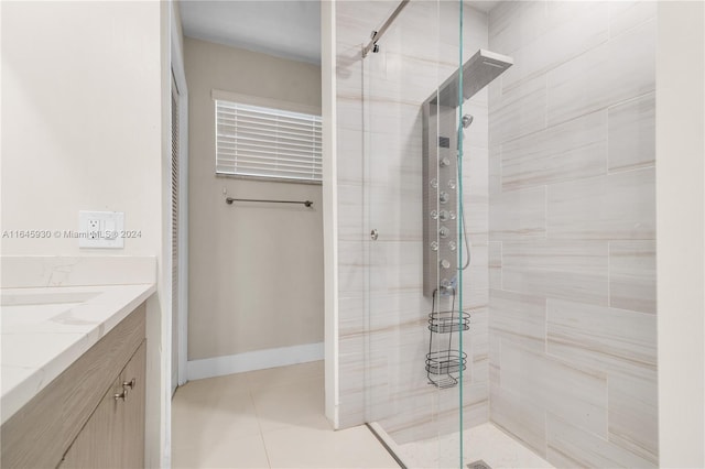 bathroom with tile patterned flooring, vanity, and an enclosed shower