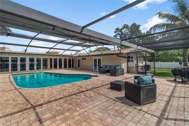 view of pool featuring french doors, a lanai, an outdoor hangout area, area for grilling, and a patio