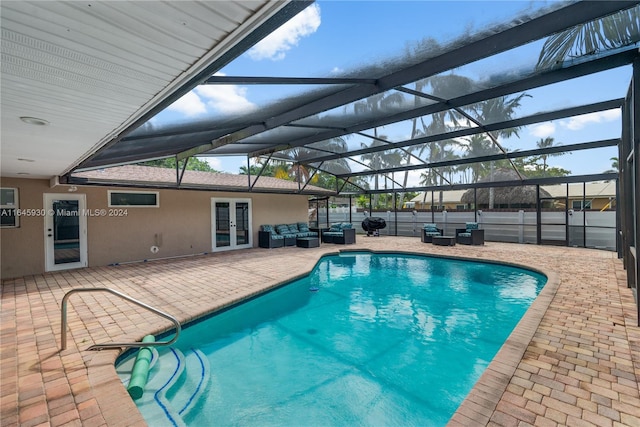 view of swimming pool featuring outdoor lounge area, glass enclosure, a patio area, and french doors