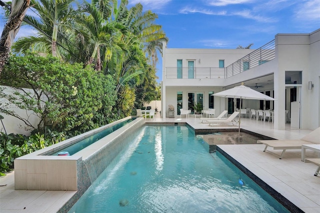 view of pool with a patio area and a hot tub