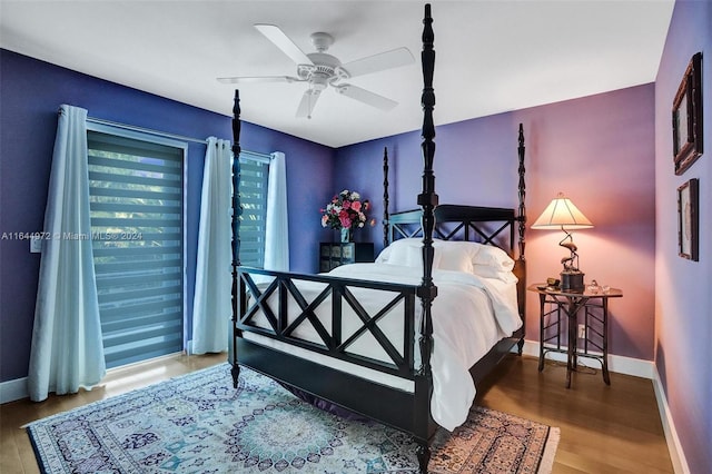 bedroom with ceiling fan and hardwood / wood-style flooring