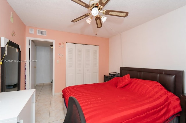 tiled bedroom featuring a closet and ceiling fan