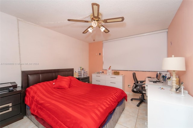 tiled bedroom with a textured ceiling and ceiling fan