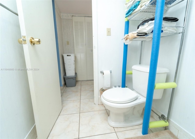 bathroom with toilet and tile patterned floors