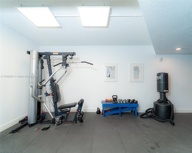 exercise room with concrete flooring and a textured ceiling