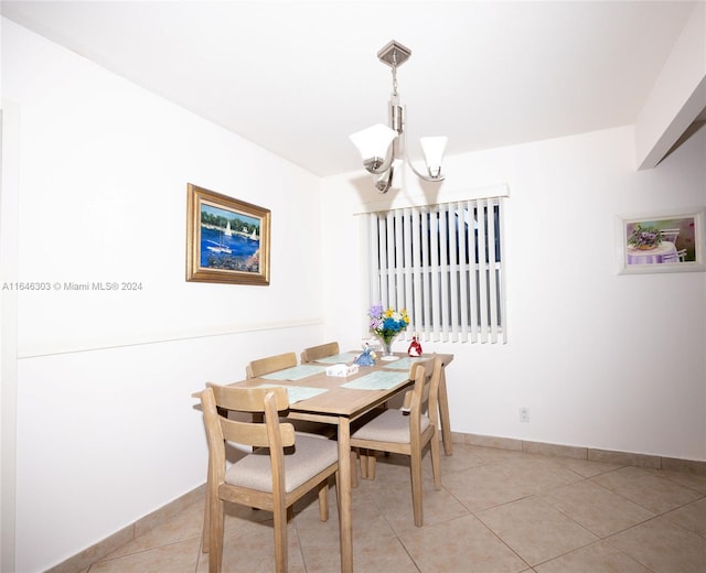 tiled dining area with a notable chandelier