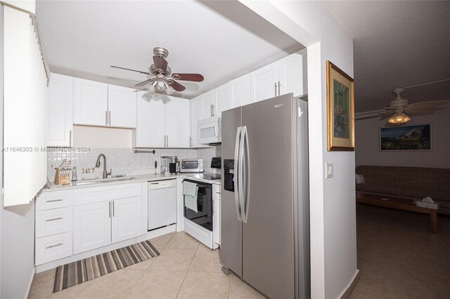 kitchen featuring white cabinets, white appliances, sink, and ceiling fan