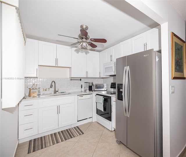 kitchen featuring white cabinets, backsplash, white appliances, sink, and ceiling fan