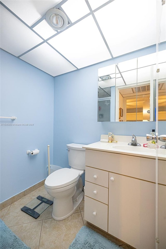 bathroom with vanity, toilet, and tile patterned floors