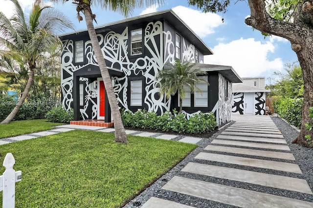 tudor-style house featuring a front yard