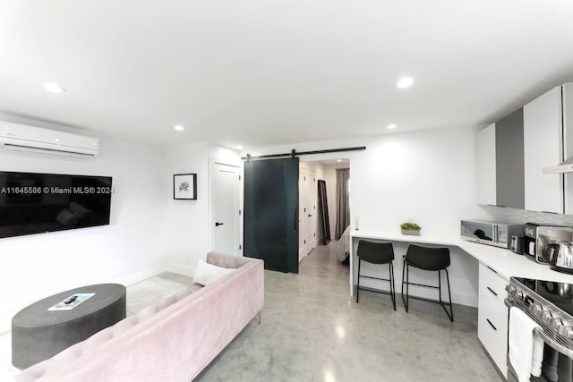 living room with a barn door and a wall mounted air conditioner