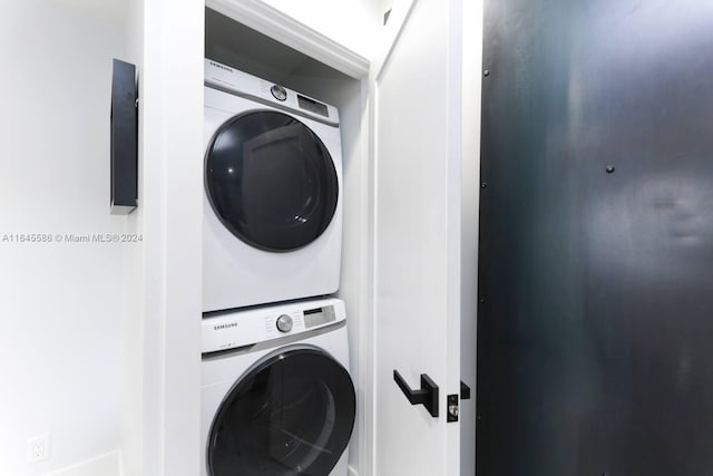 laundry room with stacked washer / dryer