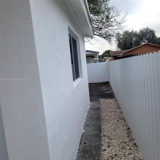 view of property exterior with a fenced backyard and stucco siding