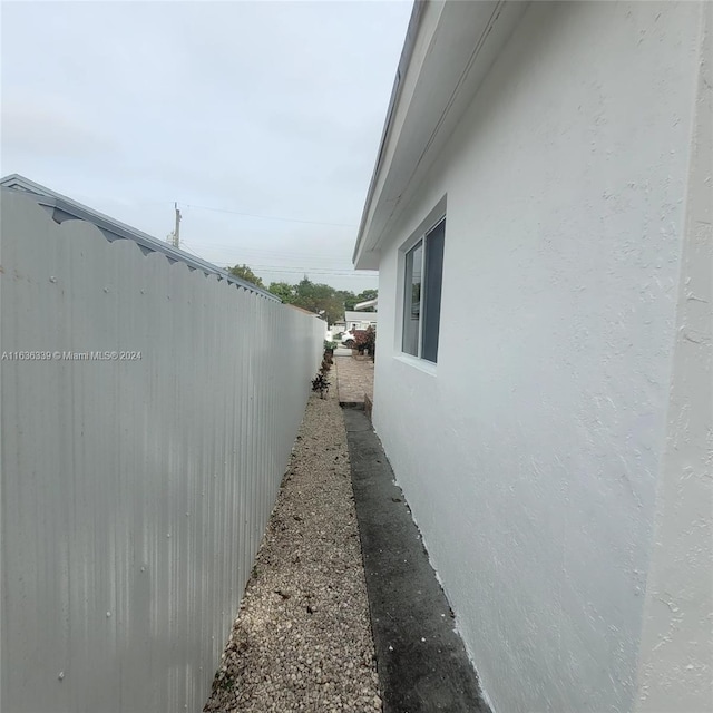 view of property exterior with fence and stucco siding