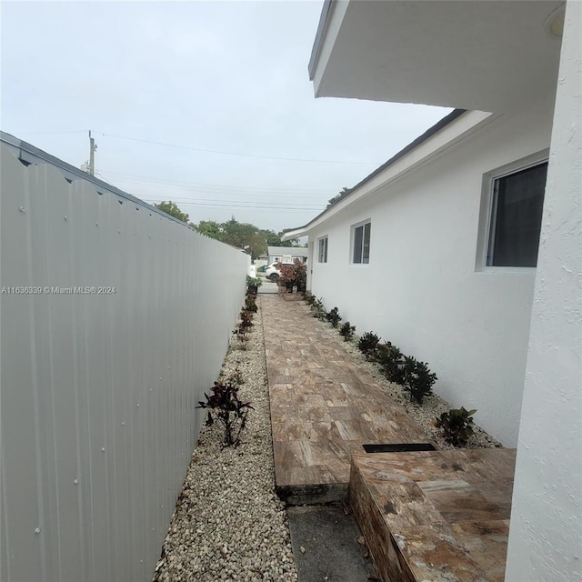 view of property exterior featuring fence and stucco siding