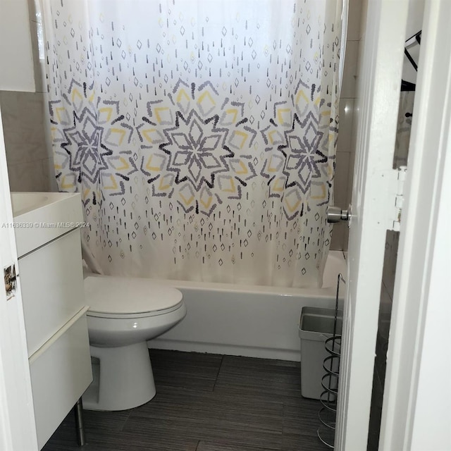 full bathroom featuring shower / bath combination with curtain, vanity, and toilet