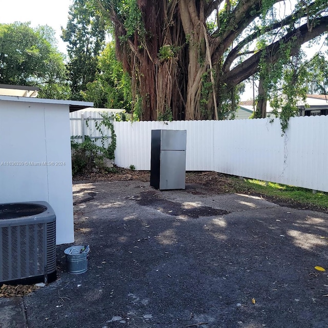 view of yard with a fenced backyard and central air condition unit