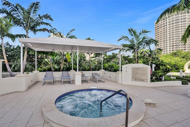 view of pool with an outdoor living space, a patio, and a community hot tub