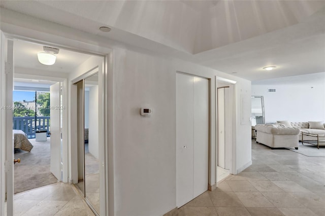 corridor featuring light tile patterned flooring