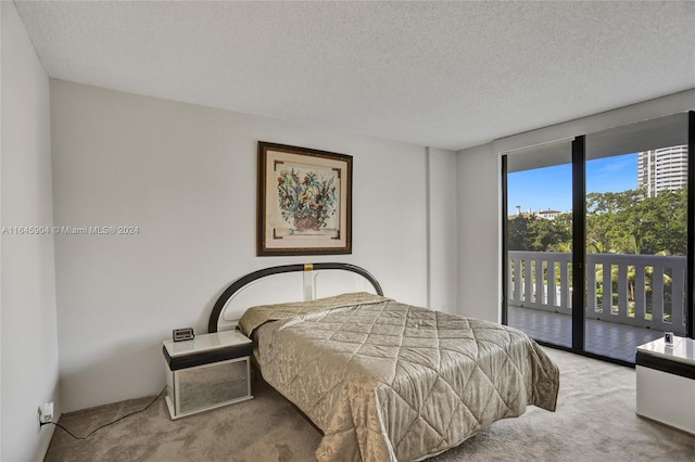 bedroom featuring a textured ceiling, access to exterior, and light carpet