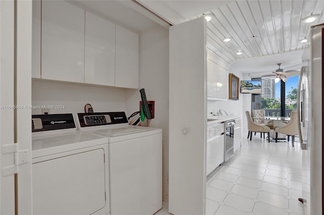 laundry room featuring ceiling fan, light tile patterned floors, and separate washer and dryer