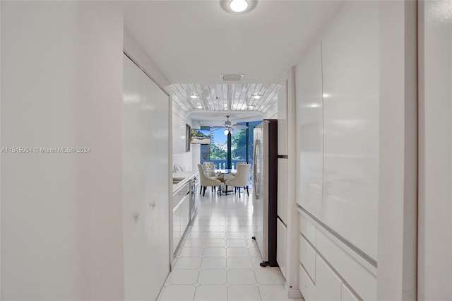 corridor featuring light tile patterned flooring