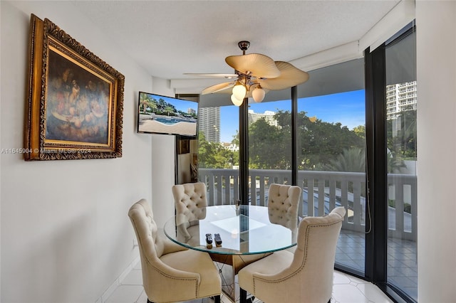 tiled dining area featuring a textured ceiling and ceiling fan