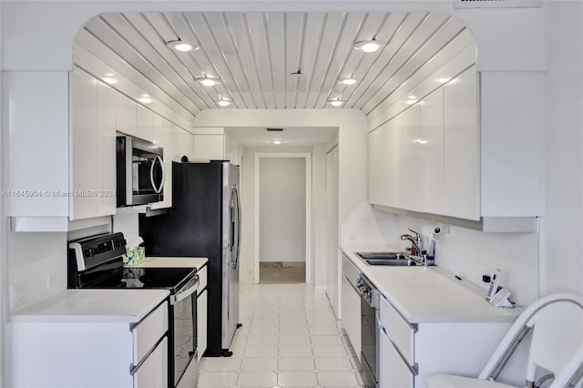 kitchen with white cabinetry, appliances with stainless steel finishes, sink, and light tile patterned flooring