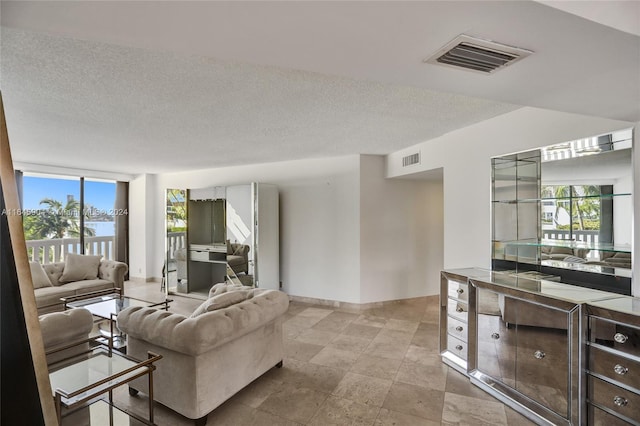 tiled living room with a textured ceiling