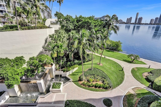 view of home's community featuring a lawn and a water view