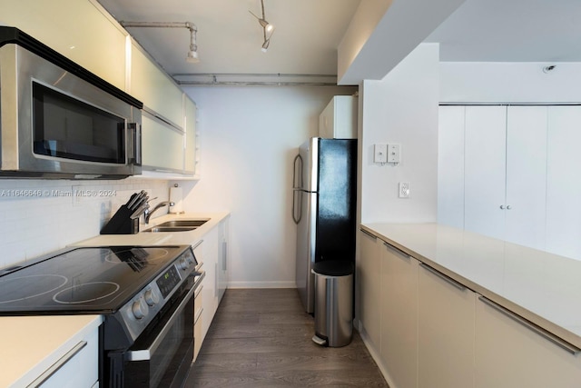 kitchen with decorative backsplash, sink, dark hardwood / wood-style floors, and appliances with stainless steel finishes