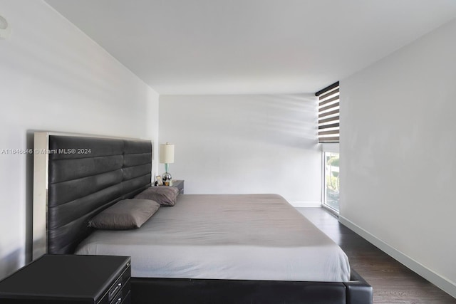 bedroom featuring dark hardwood / wood-style flooring