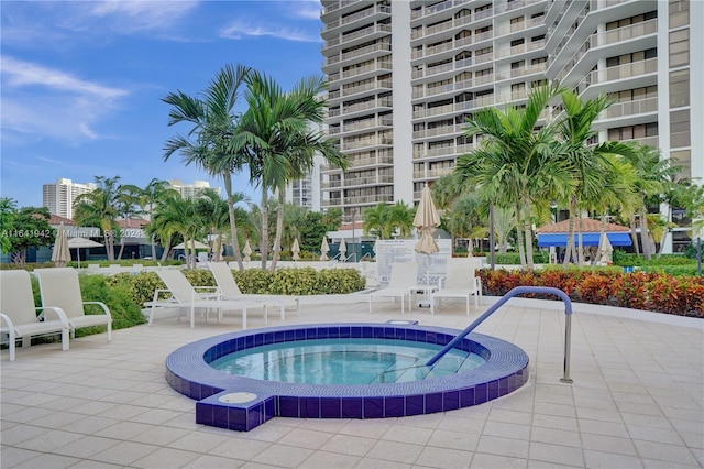 view of swimming pool featuring a hot tub