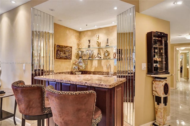 bar with light stone counters and sink