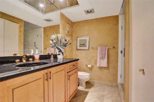 bathroom with walk in shower, vanity, toilet, and tile patterned floors