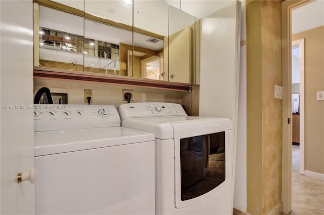 laundry room with light tile patterned floors and washer and dryer