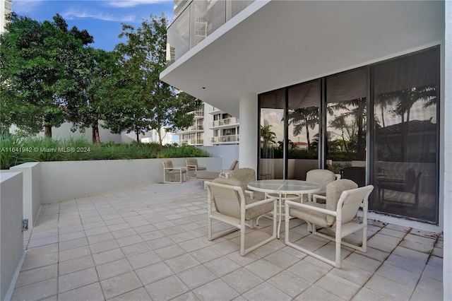 view of patio featuring a balcony