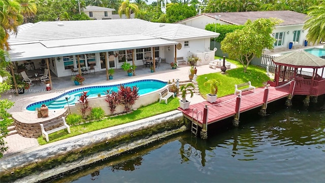 back of house featuring a patio and a water view