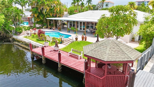 back of house featuring a gazebo, a patio area, a water view, and a fenced in pool