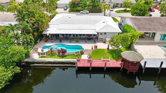 back of property featuring a patio area and a water view