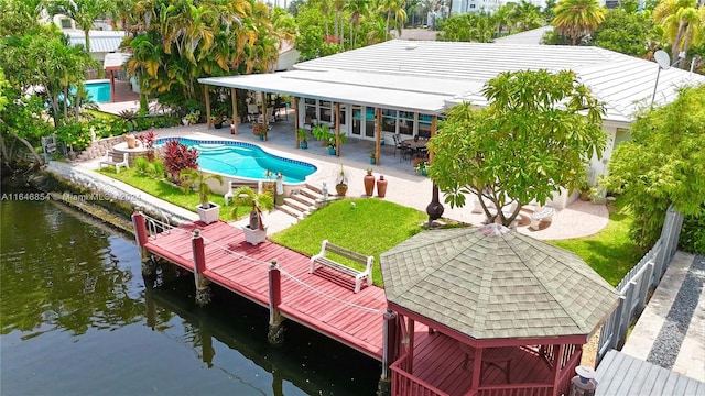 rear view of property with a water view and a patio