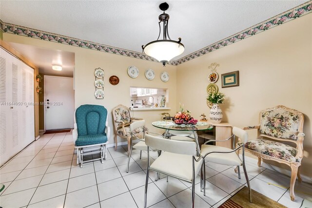 tiled living room featuring a textured ceiling